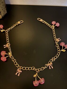 Gold Tone Cherry Charm, with Pink Glitter Charms that will dress up any bag!